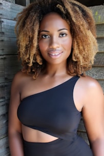 A smiling person posing naturally inside a stylish photo booth at an event.