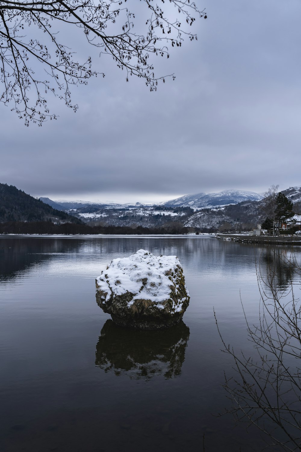 a large rock in the middle of a lake