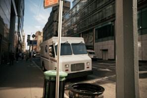 A delivery truck parked outside a modern distribution center.