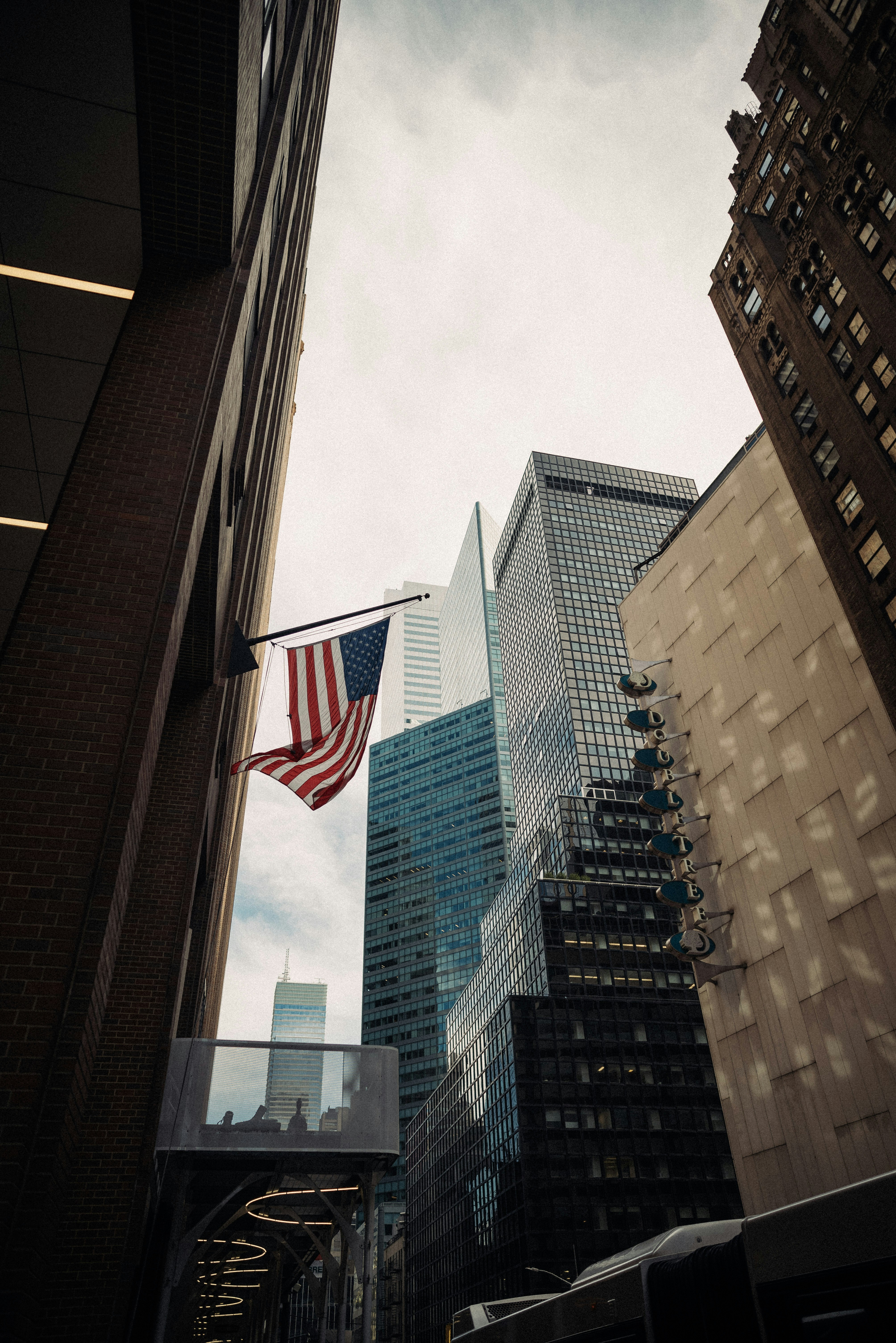 the american flag is flying in the city
