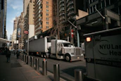 A hotshot truck navigating city streets with precision and care.