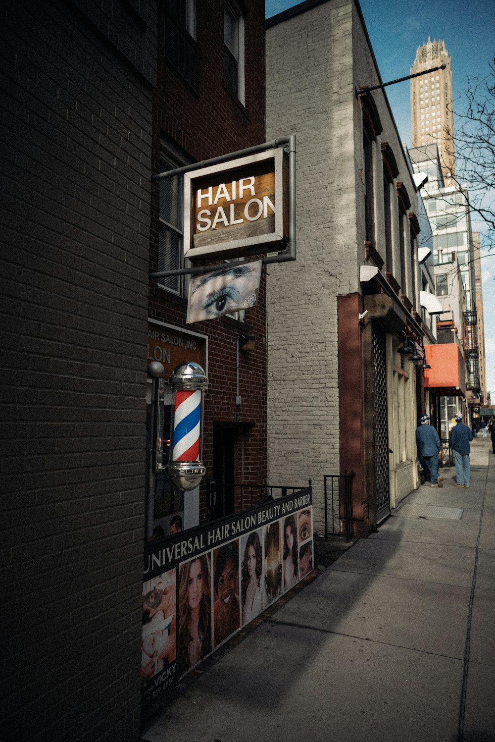 a hair salon sign on the side of a building