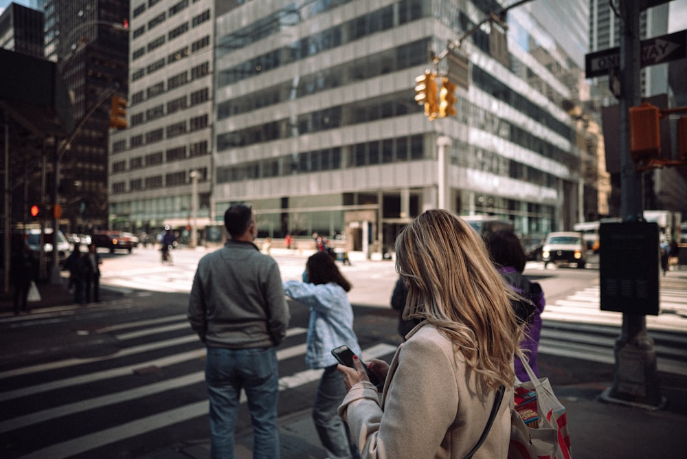 a group of people walking across a street