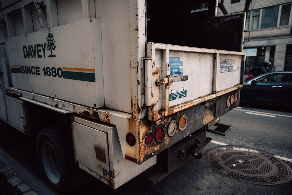 a garbage truck parked on the side of the road
