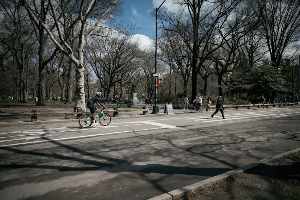 a man riding a bike down a street