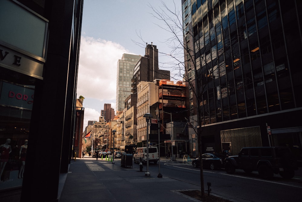 a city street lined with tall buildings next to tall buildings