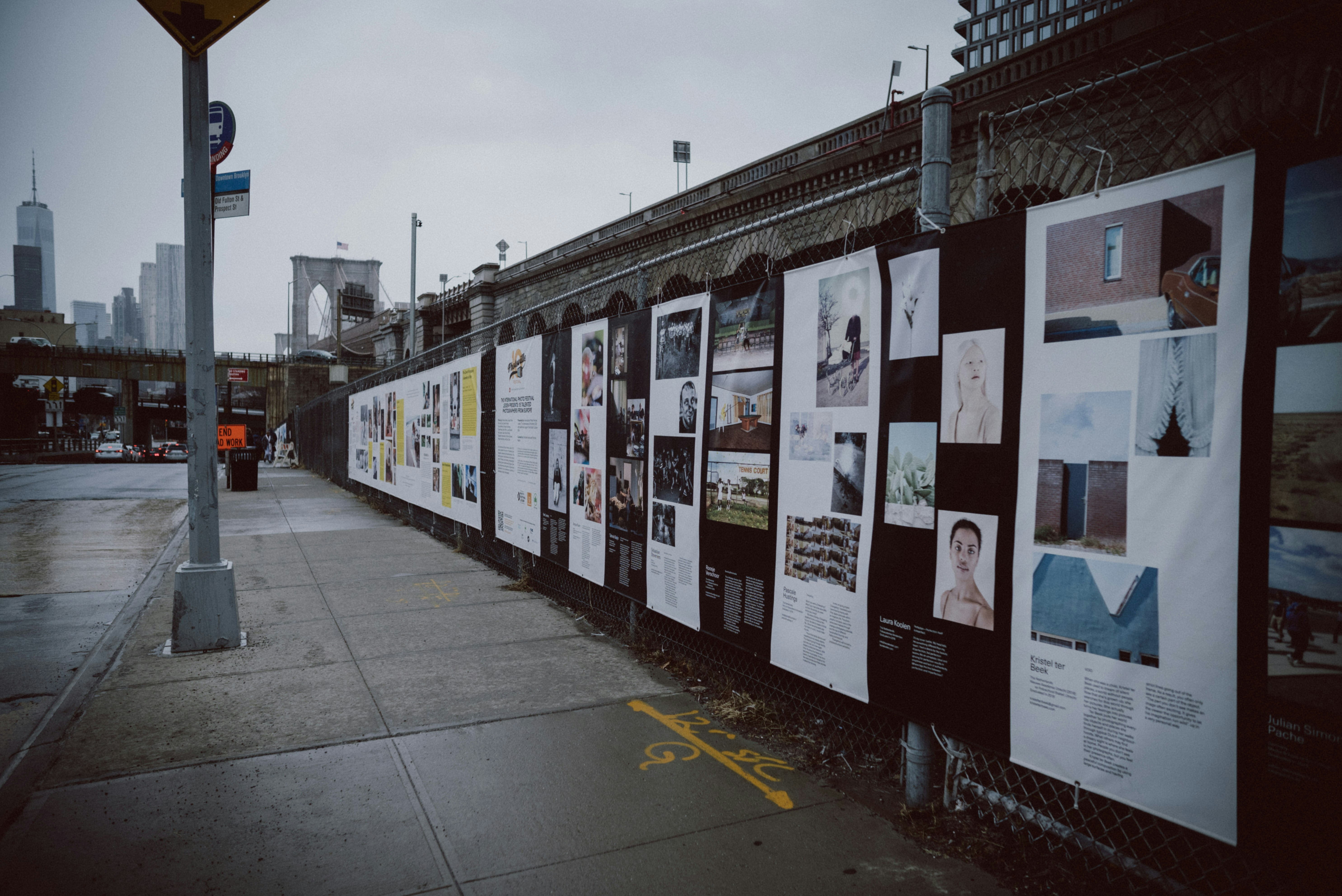 a bunch of posters on the side of a building