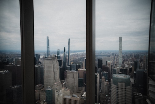 City skyline viewed from an office window symbolizing global reach.