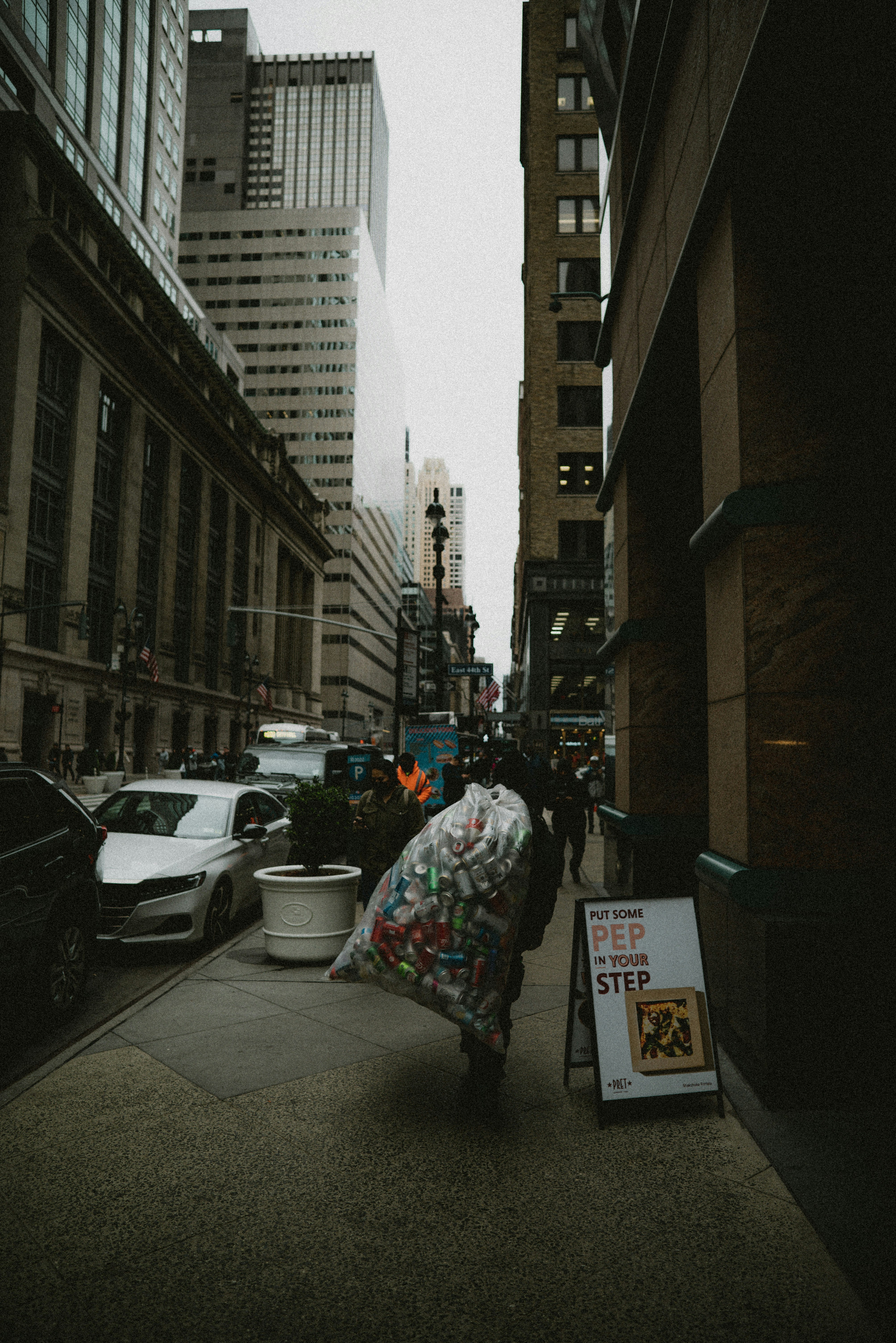a person walking down a street holding a bag