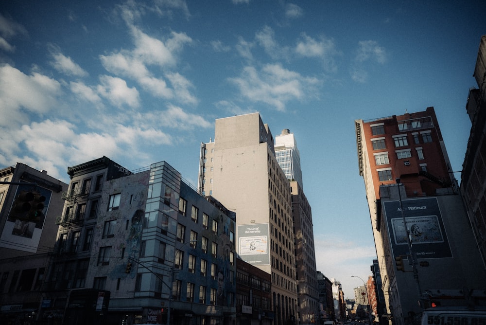 a city street filled with tall buildings under a blue sky