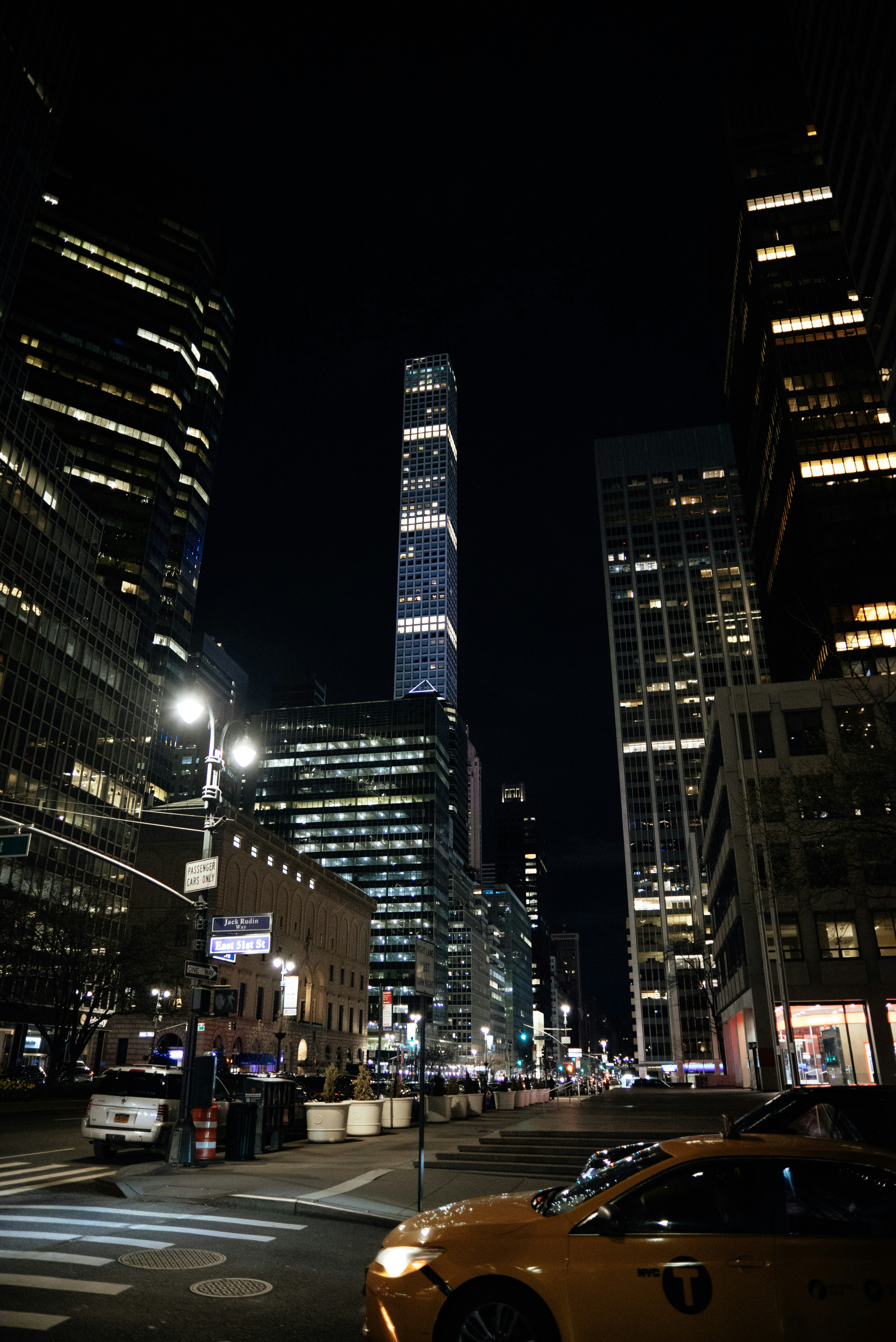A city street at night with tall buildings photo – Free Usa Image on ...