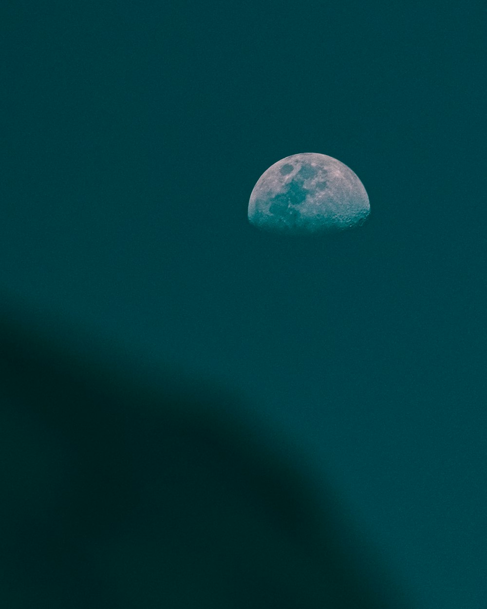 a full moon is seen in the night sky