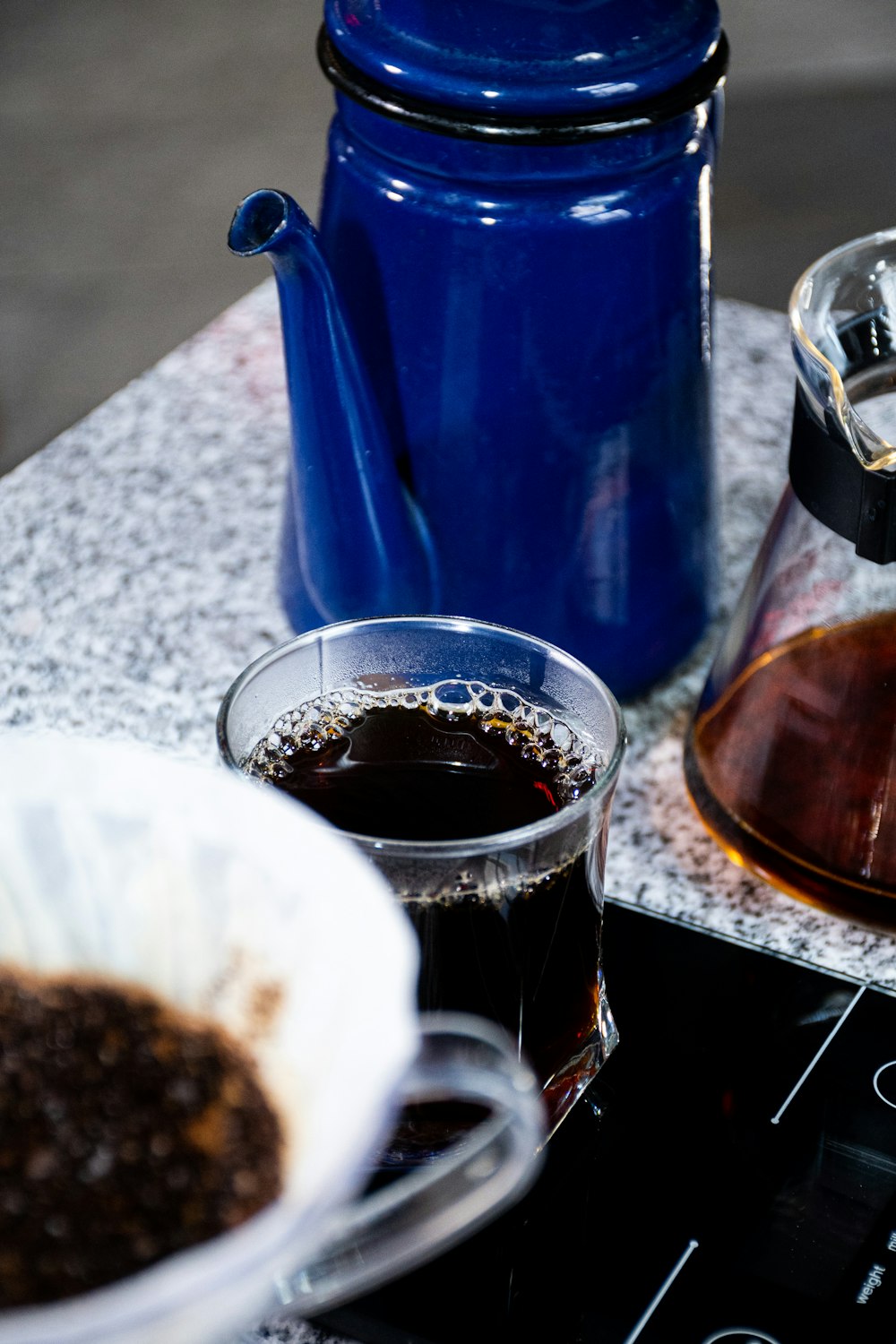 a cup of coffee sitting on top of a stove