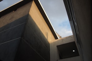Side view of a building corner highlighting the crisp lines of a gray facade coating