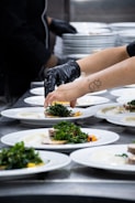Chef plating fresh salads in a professional kitchen