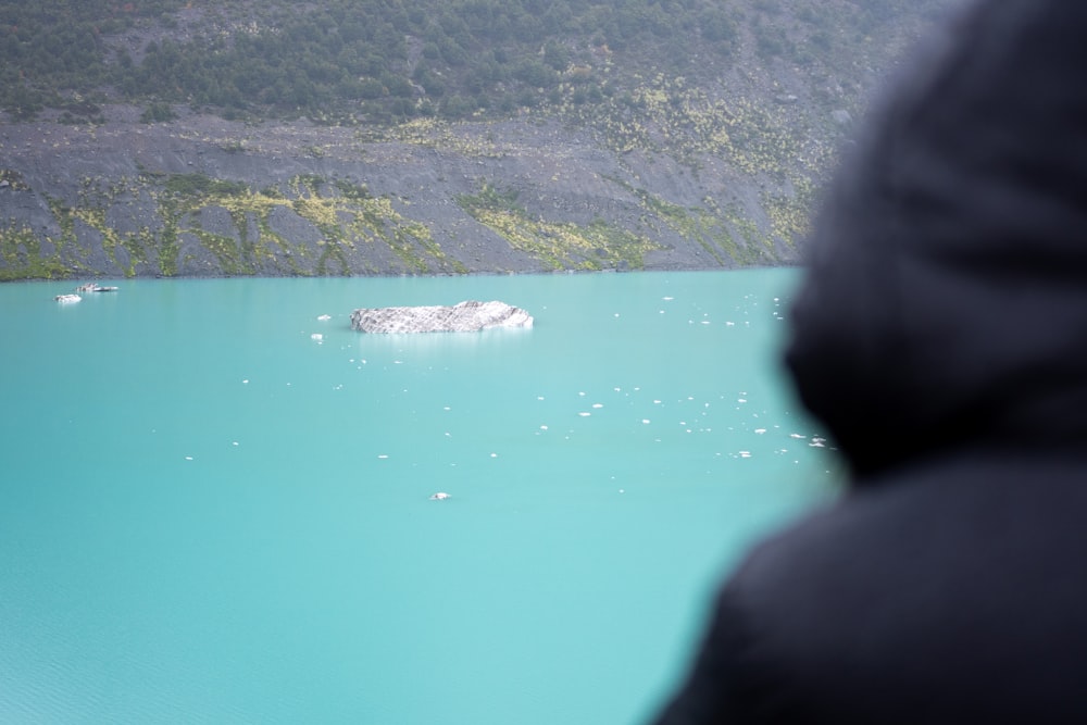 a person standing in front of a large body of water