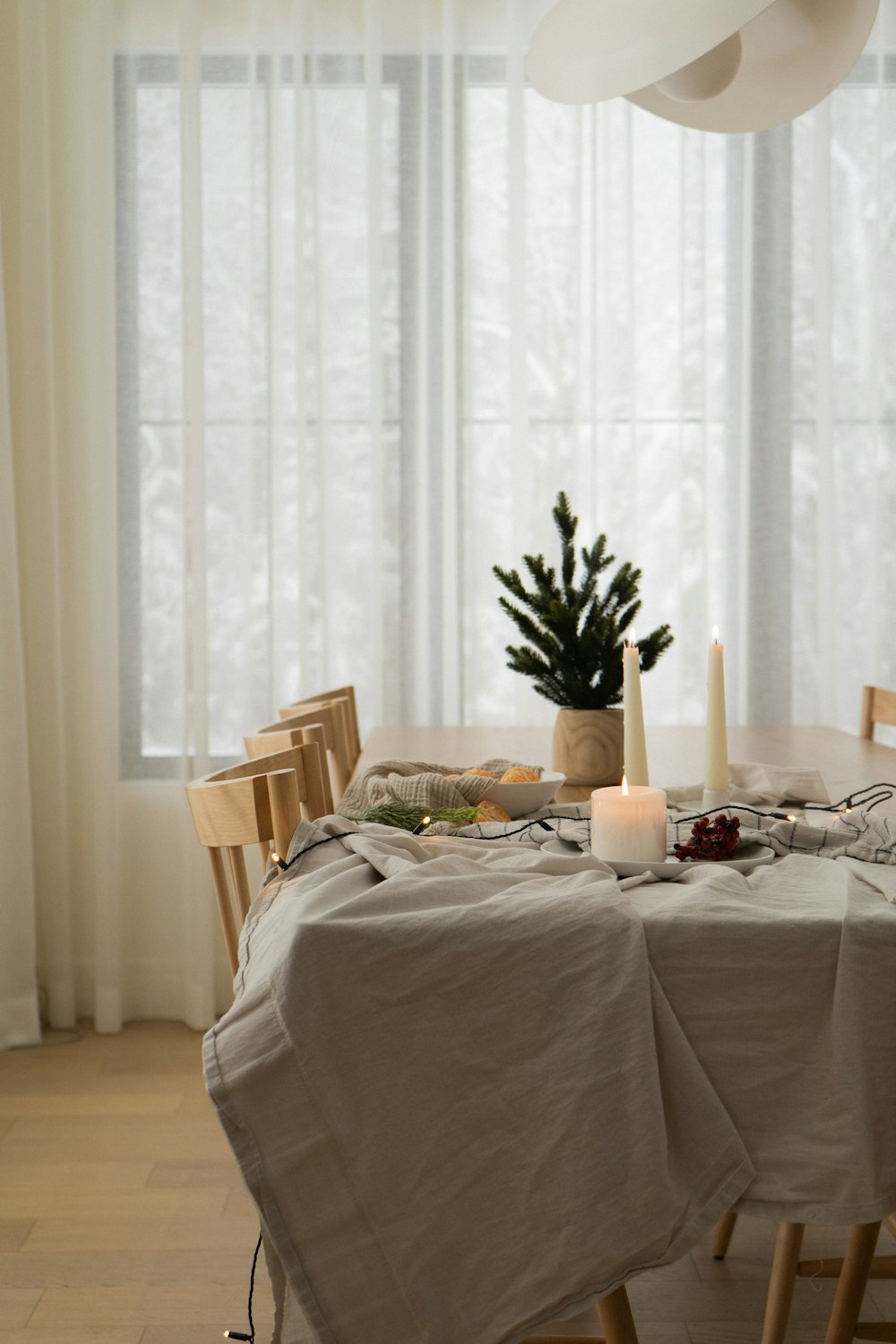 a dining room table with a christmas tree in the corner