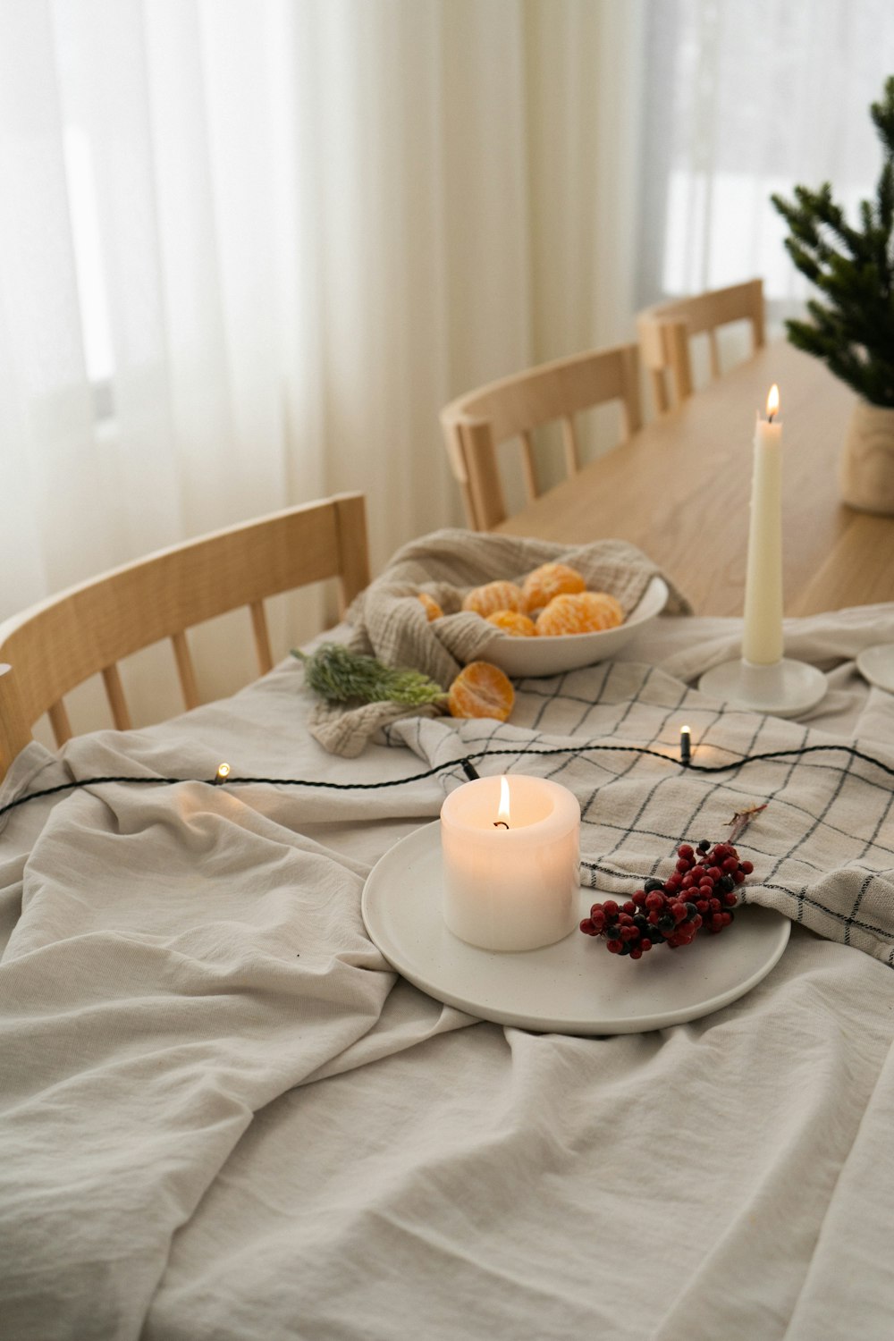 a white candle on a plate on a table