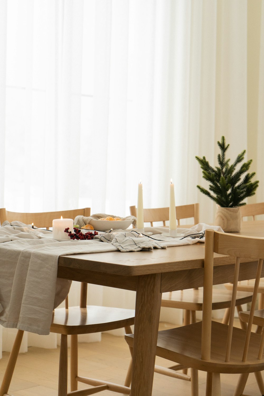 a dining room table with a white table cloth on it
