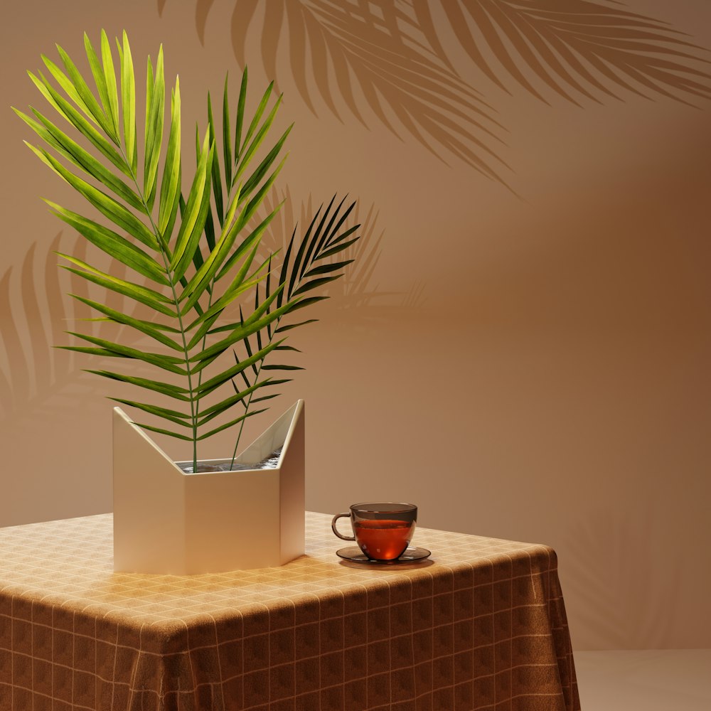 a table with a plant and a cup on it