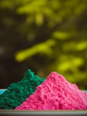 Green pigment powder forming a smooth pile on a dark background.