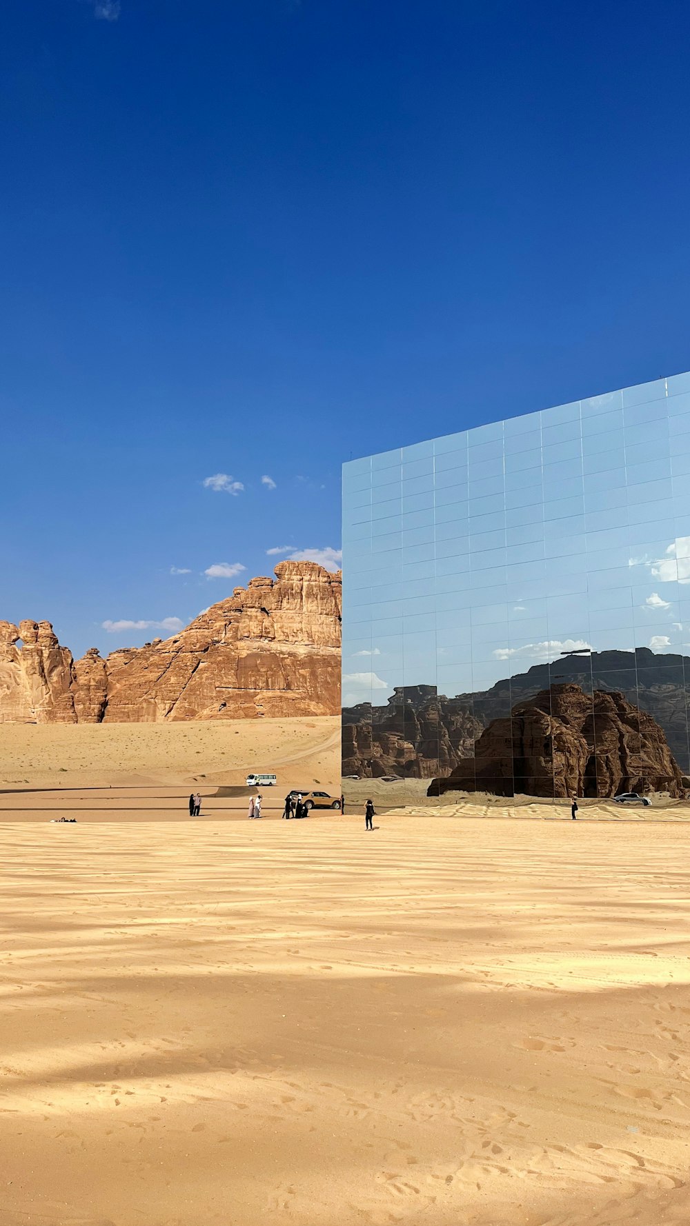 a desert scene with a large mirror in the middle