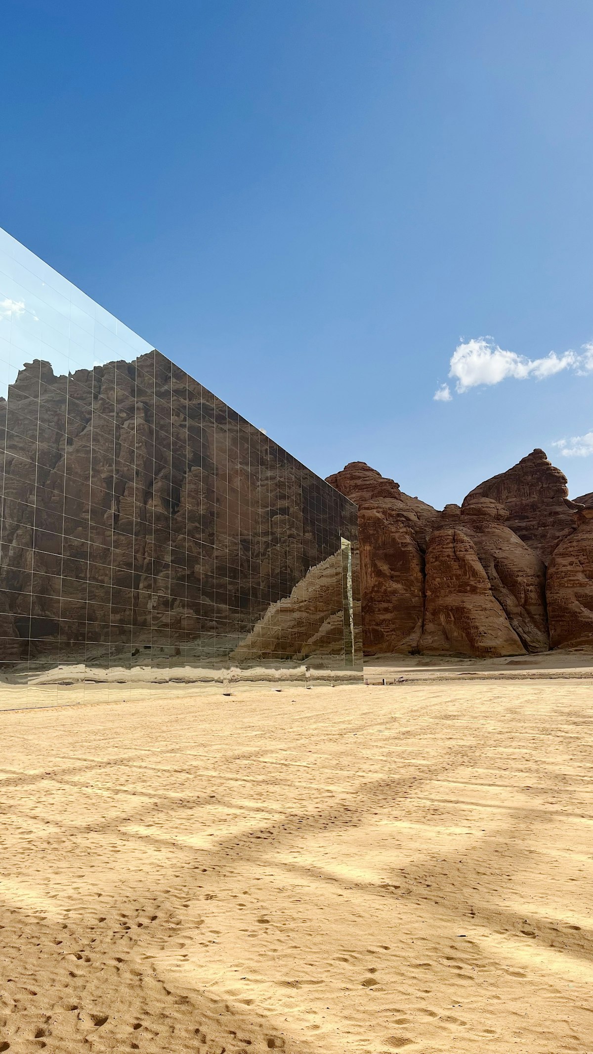 AlUla Maraya — the mirrored concert hall reflecting desert sky and sandstone cliffs