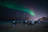 Couple watching northern lights in Murmansk with warm clothing