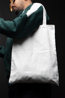 a man holding a white tote bag