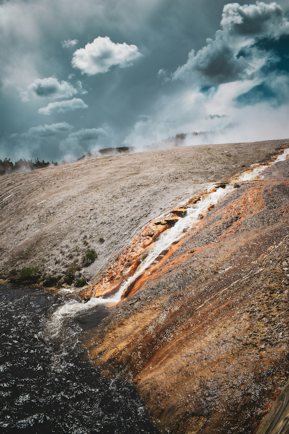 a stream of water running down the side of a hill