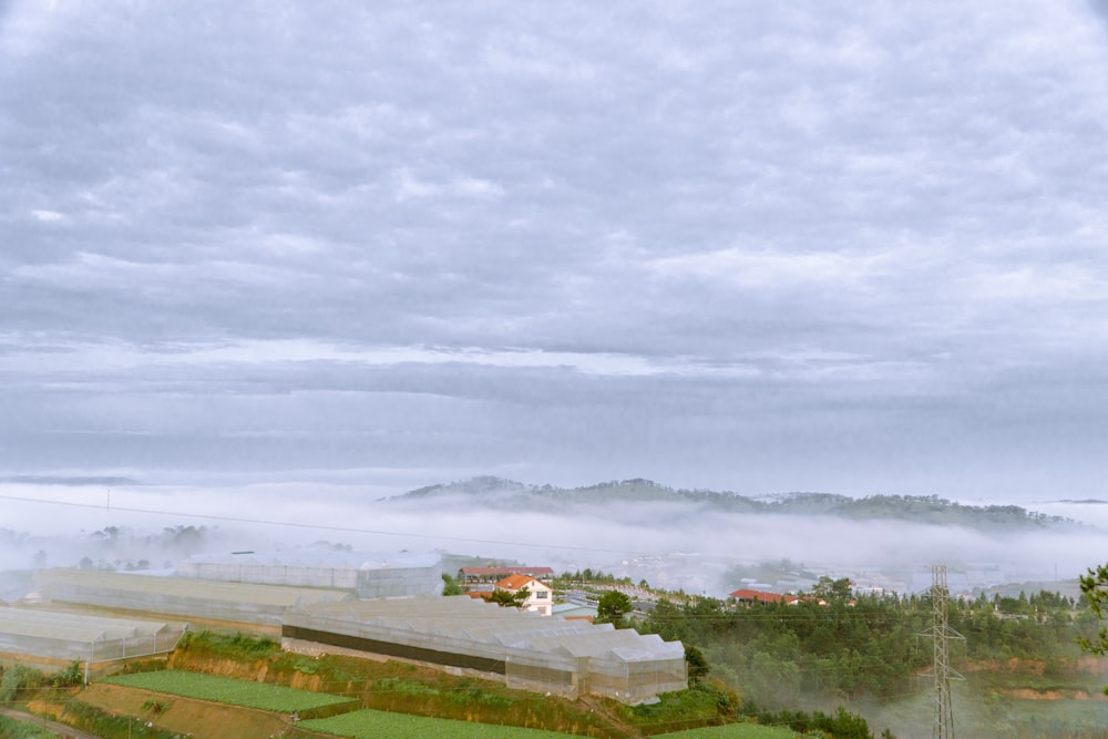 a view of a foggy landscape from a hill