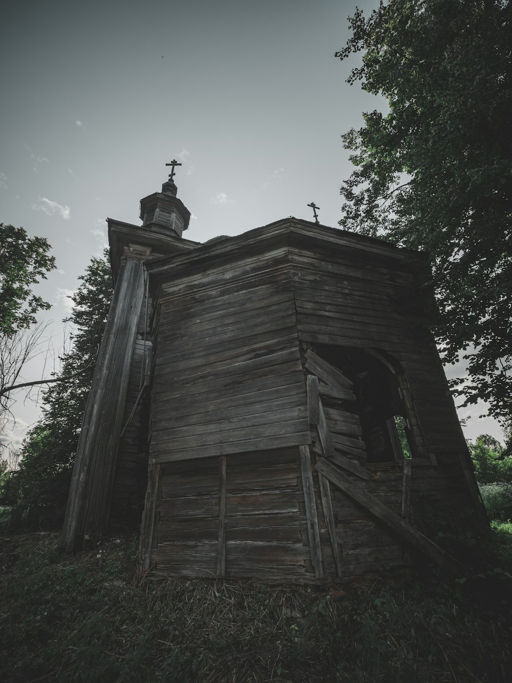 an old wooden church with a steeple on top