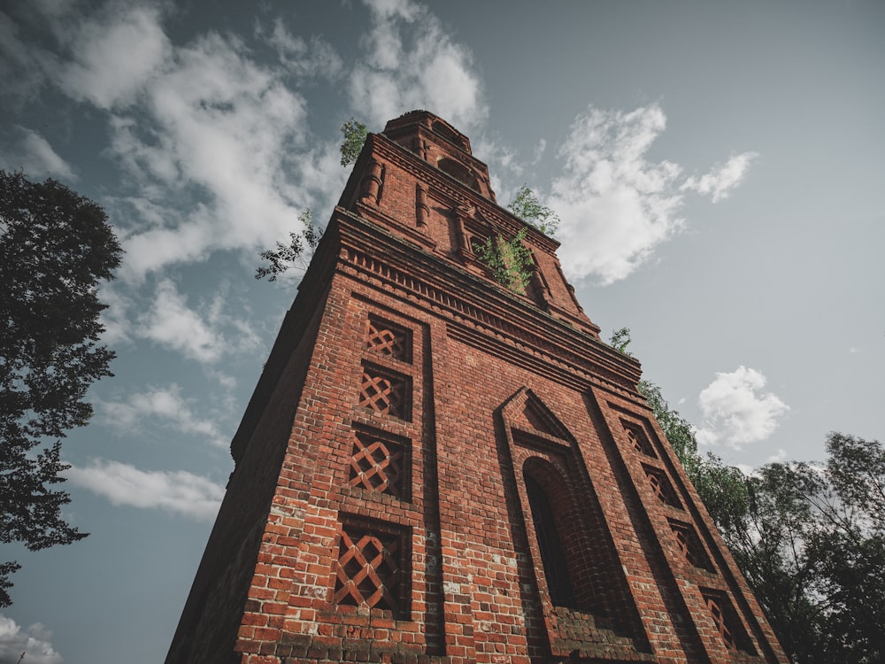 a tall brick tower with a clock on the top