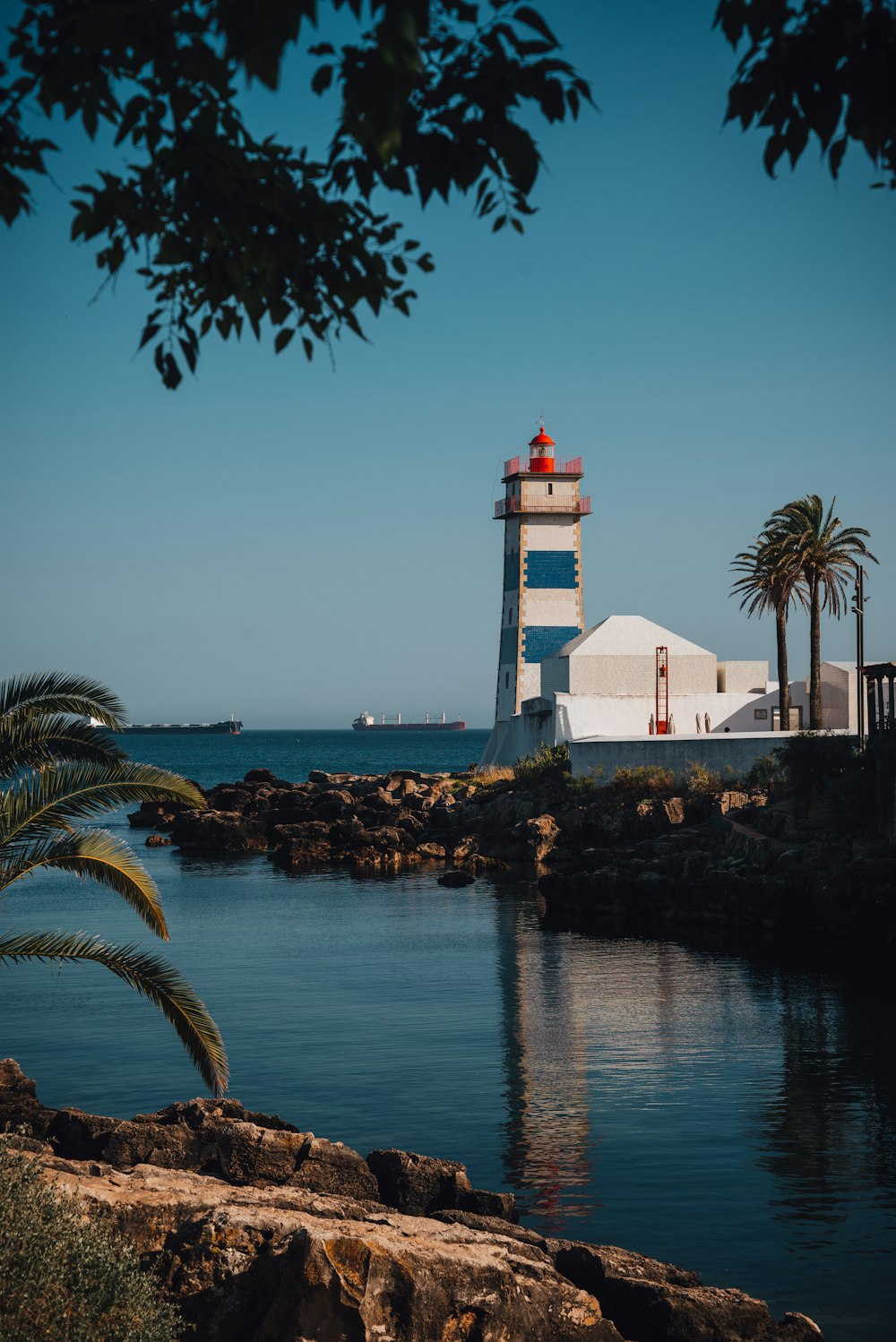 a light house sitting on top of a body of water