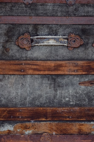 A rustic wooden trunk with metal accents, hinting at stories from decades past.