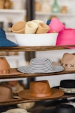 A lineup of exclusive hats from brands Dandy and 31hats displayed on wood table