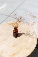 A serene morning scene with a minimalist supplement bottle on a wooden table bathed in soft natural light.