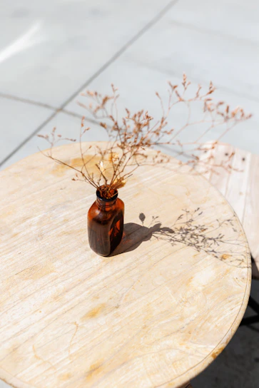 A sleek, compact oxygen canister resting on a wooden table bathed in natural light.