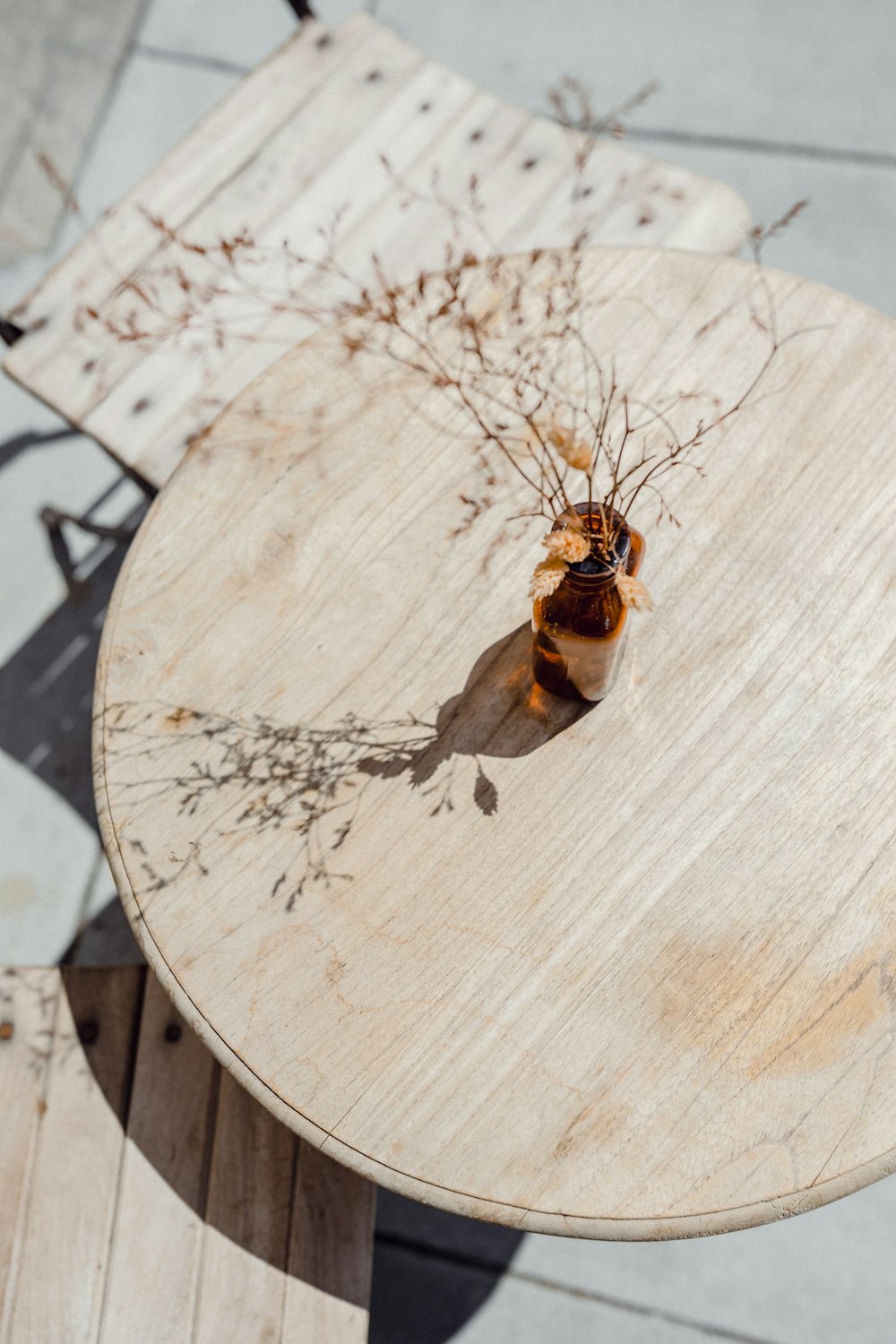 a wooden table with a vase of flowers on top of it