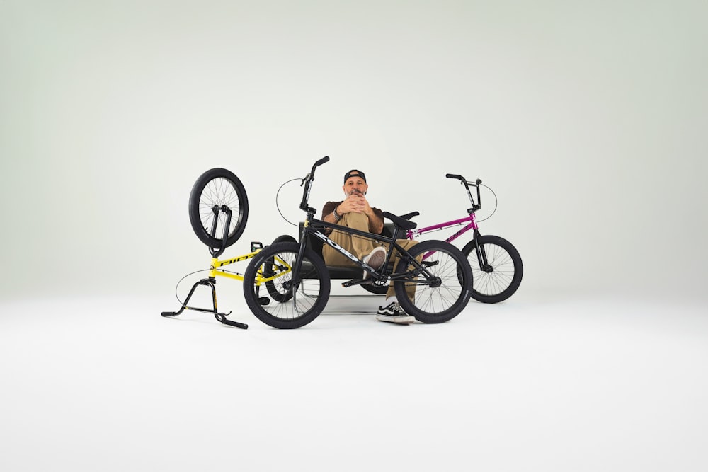 a man sitting in a bike with a bicycle rack attached to it