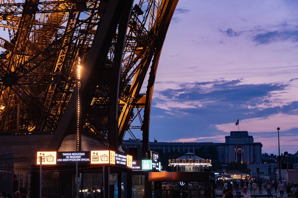 the eiffel tower is lit up at night