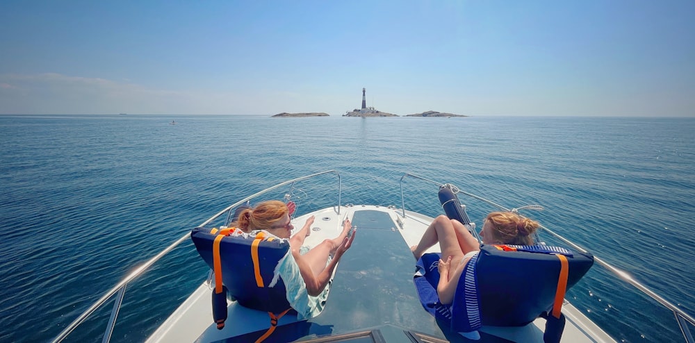 a couple of people sitting on top of a boat