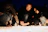 A group of people happily crafting candles together at a Lumiflamme event.