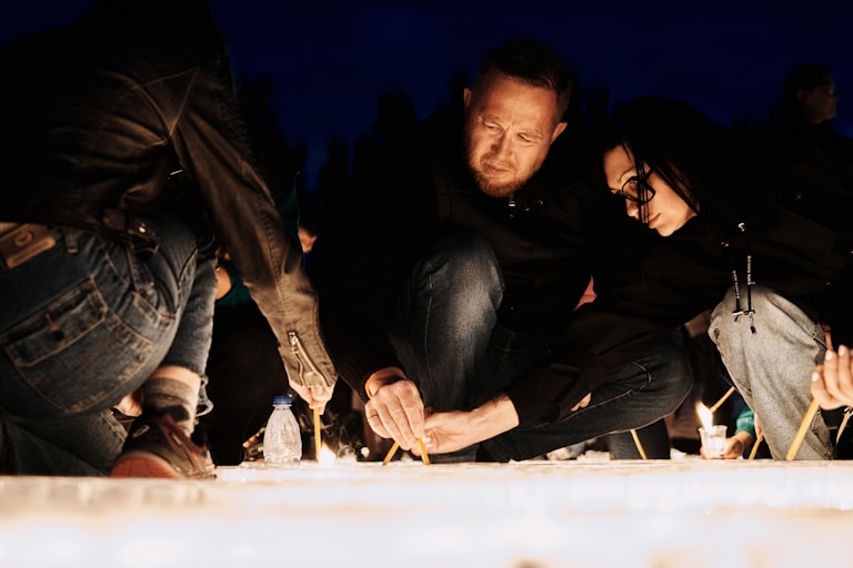 Young people lighting candles