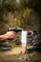 Police officers training with firearms on a shooting range.