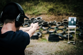 a man is aiming a gun at a target