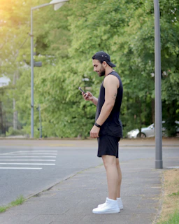 Vibrant lifestyle shot of a person using a smart device outdoors in a sunny urban park
