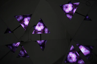Abstract geometric shapes glowing in violet and deep purple, symbolizing AI connections.