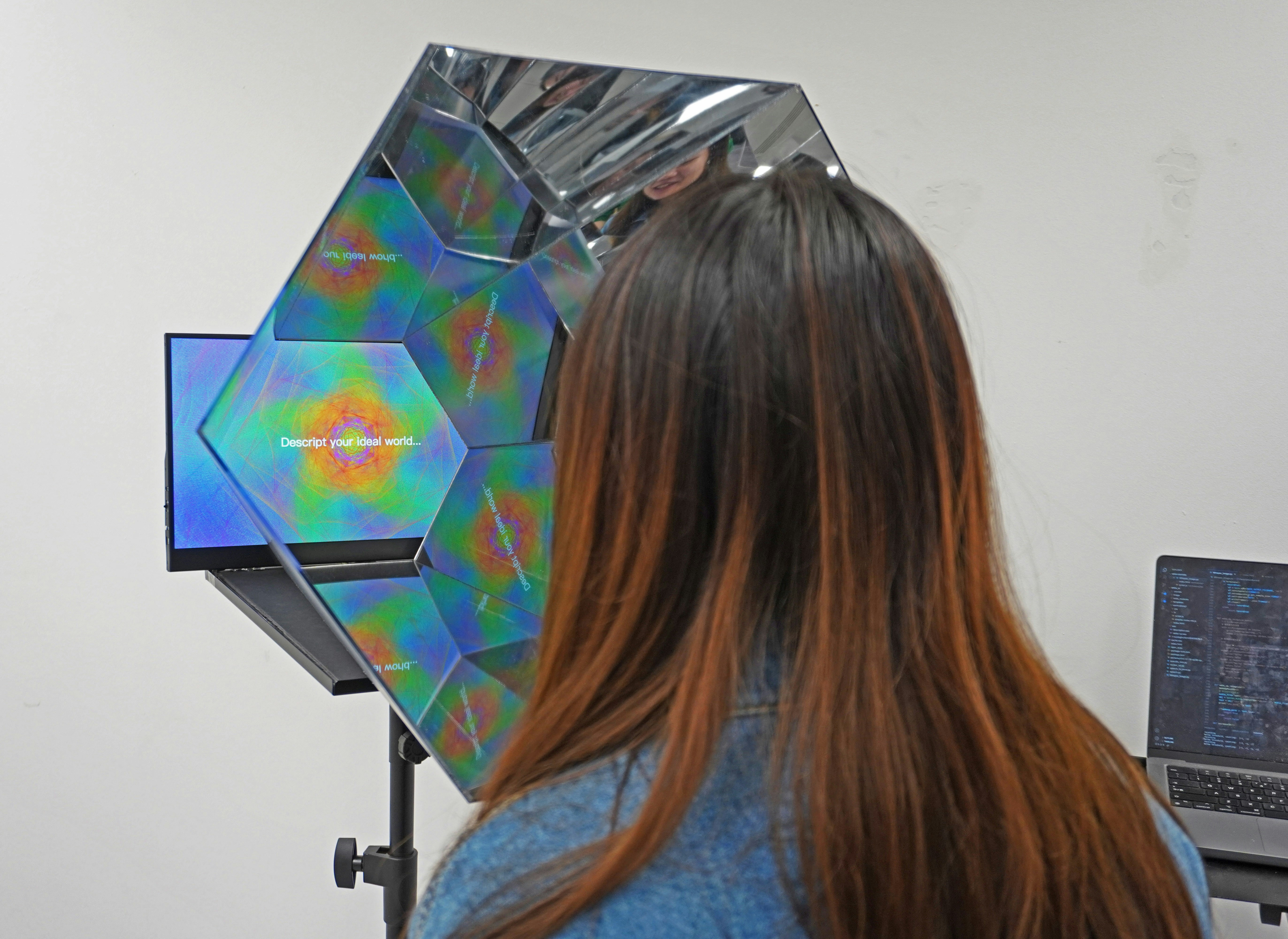 a woman standing in front of a laptop computer