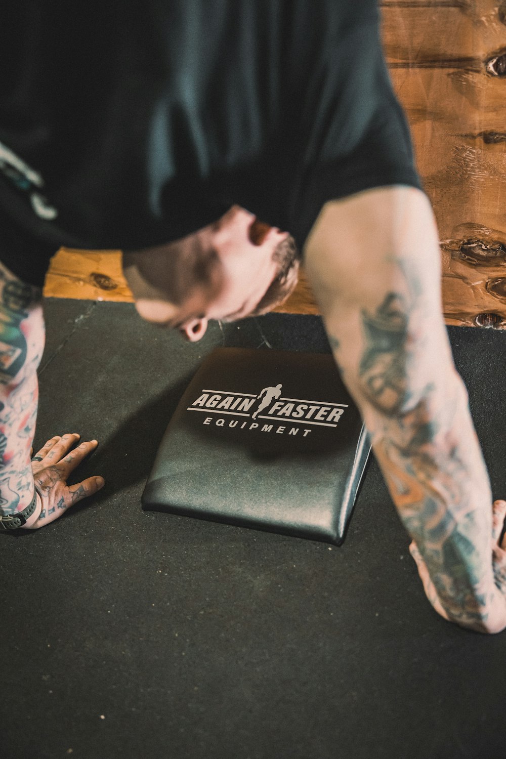 a man bending over with his foot on a mat